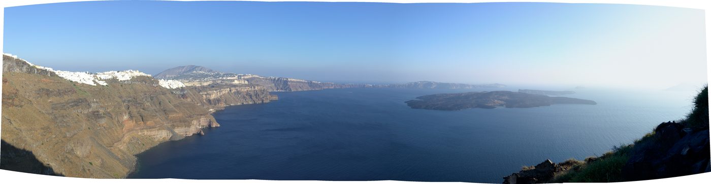 Panoramic view of the Santorini caldera from Skaros rock, showing Nea Kameni volcano