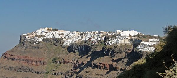 The village of Imerovigli perched on the caldera rim, seen from Fira