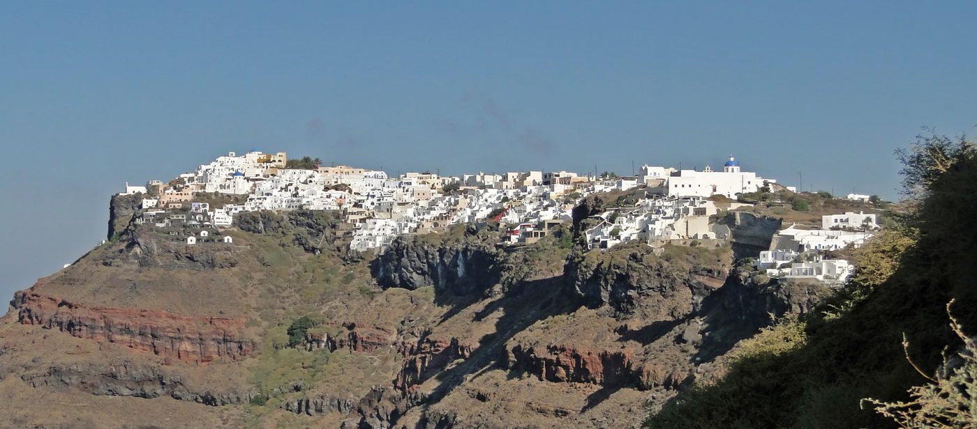 The village of Imerovigli perched on the caldera rim, seen from Fira