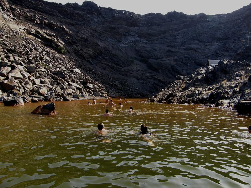 People swimming in the warm volcanic waters near Palea Kameni, Santorini.