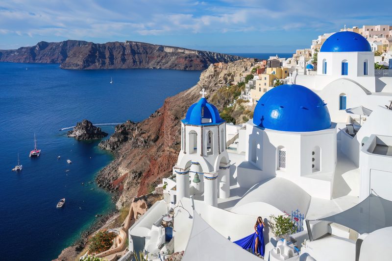 Three iconic domes nestled in the picturesque village of Oia, Santorini.