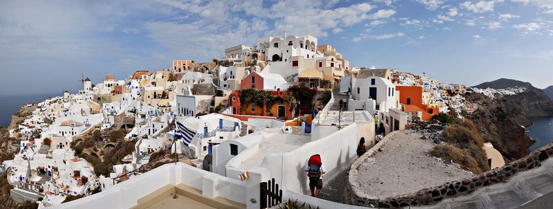 A panoramic view of the iconic white buildings of Oia on Santorini, Greece.