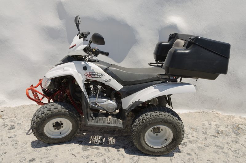 A SYM Quadlander 200 ATV parked in Imerovigli, Santorini, Greece.