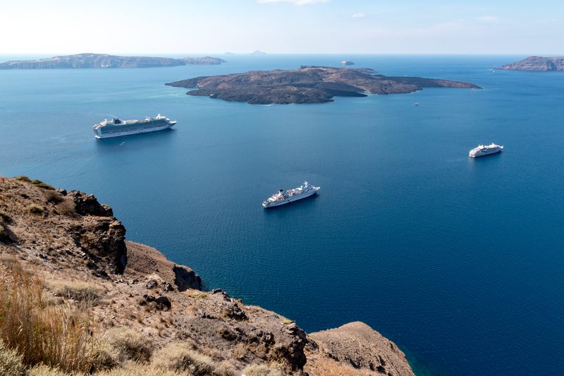 A stunning view of the caldera in Fira, Santorini, Greece, with white buildings and the deep blue sea.