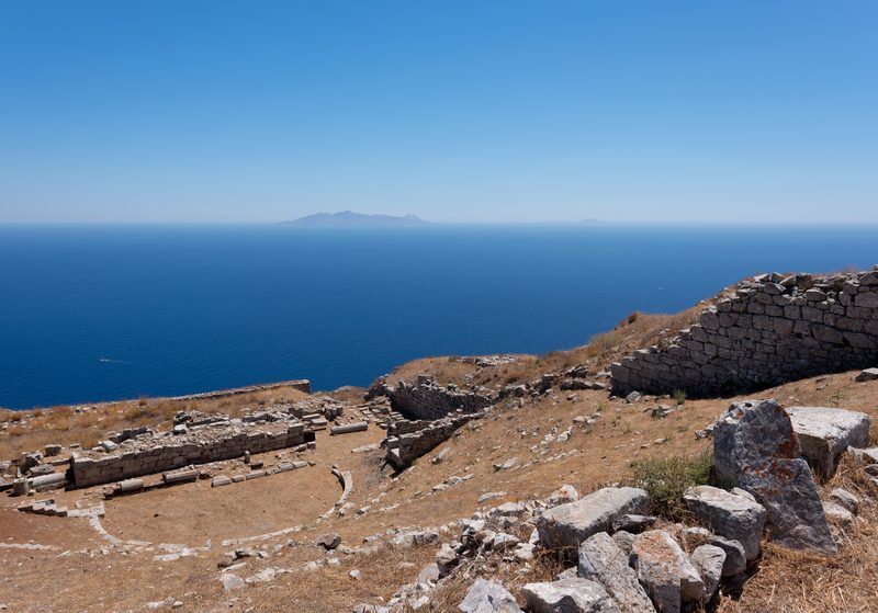 An ancient Greek theatre in Thera, Santorini, with Anafi Island in the background.