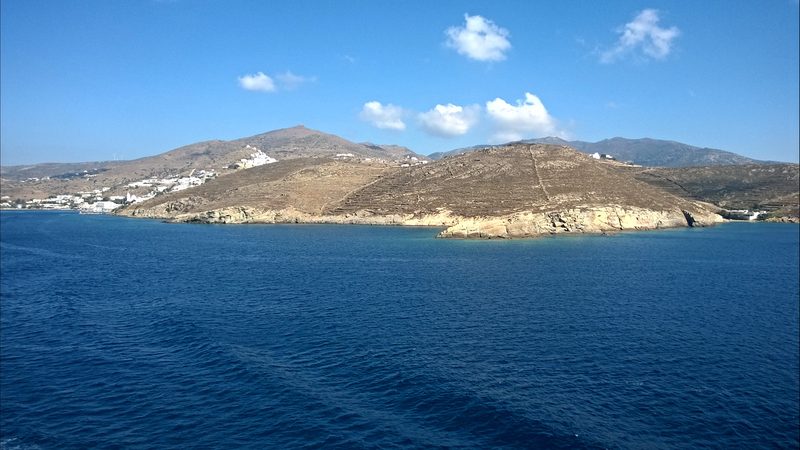 A scenic coastal road winds through the picturesque landscape of Ios, Greece.
