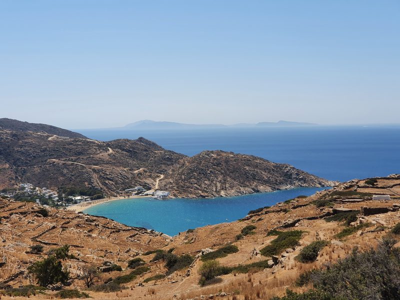 A turquoise bay and sandy beach on Ios seen from the hillside above