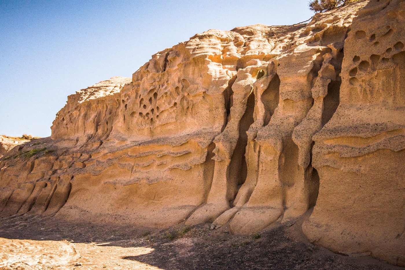 Wind-carved sandstone cliffs at Monolithos, Santorini