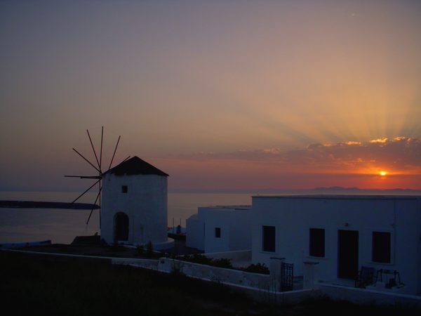 Golden sunset over the village of Oia, Santorini, with the caldera below