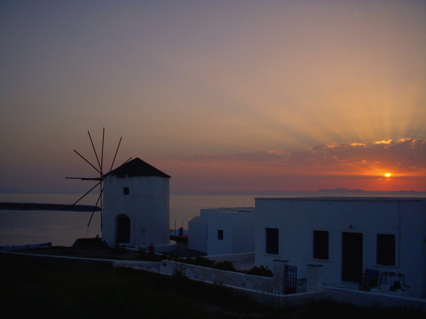 Golden sunset over the village of Oia, Santorini, with the caldera below