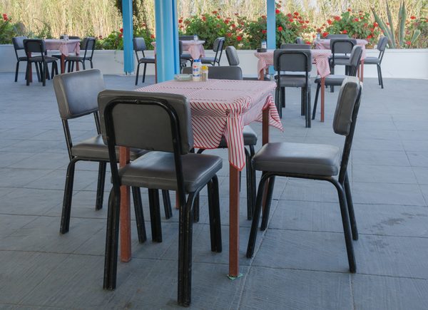 Small tables outside the Taverna Delfini restaurant in Santorini, Greece