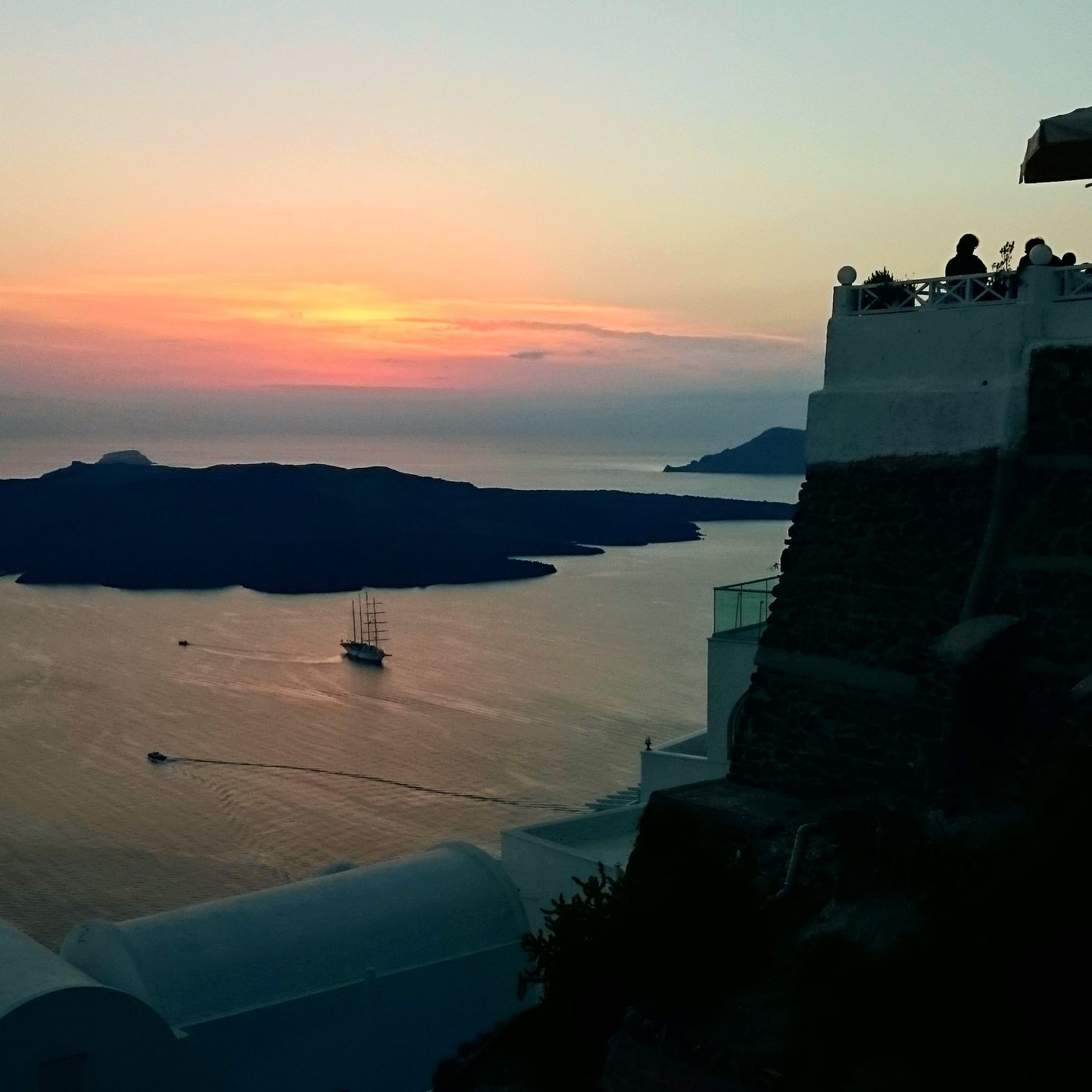Golden sunset light over the Santorini caldera seen from Imerovigli