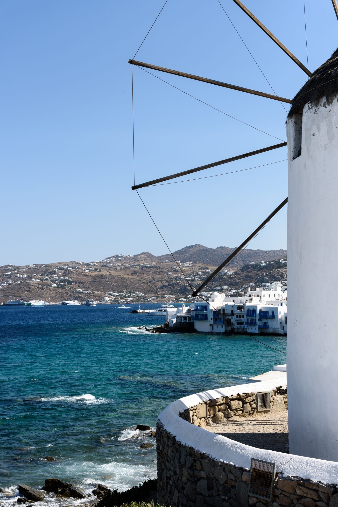 Boats moored in Mykonos harbour with the town behind