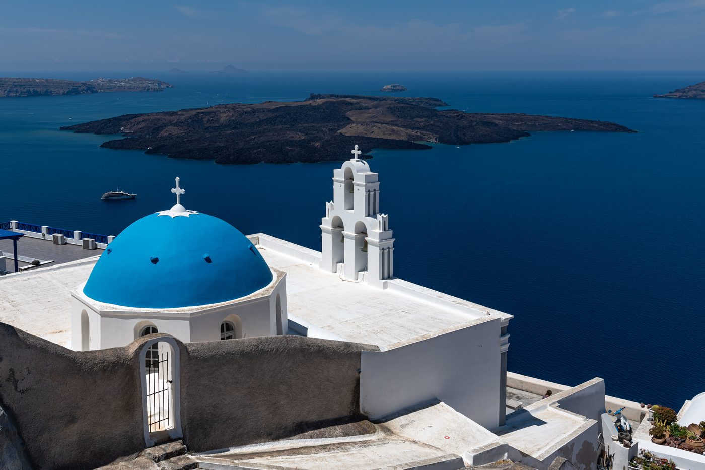 A classic blue-domed church against the whitewashed buildings of Santorini